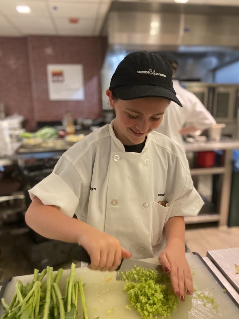 Cooking camp student in action